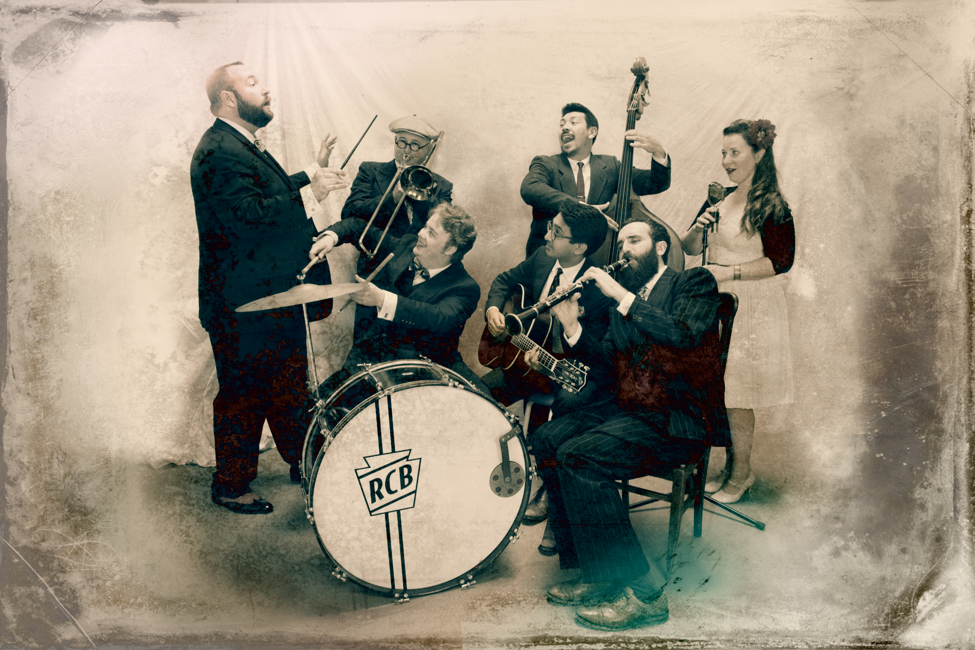 Seven musicians playing their instruments in a vintage-looking photograph.