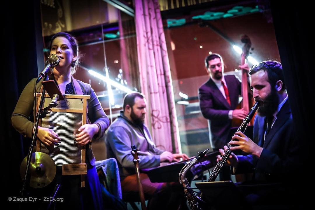 A jazz quartet playing on a small stage.